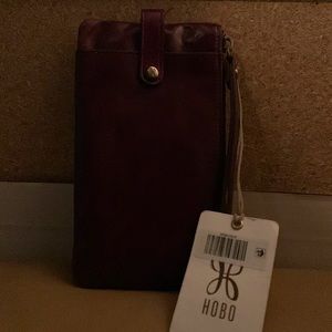 HOBO WRISTLET/WALLET EGGPLANT. It looks like wine or burgundy color. New w/tag.